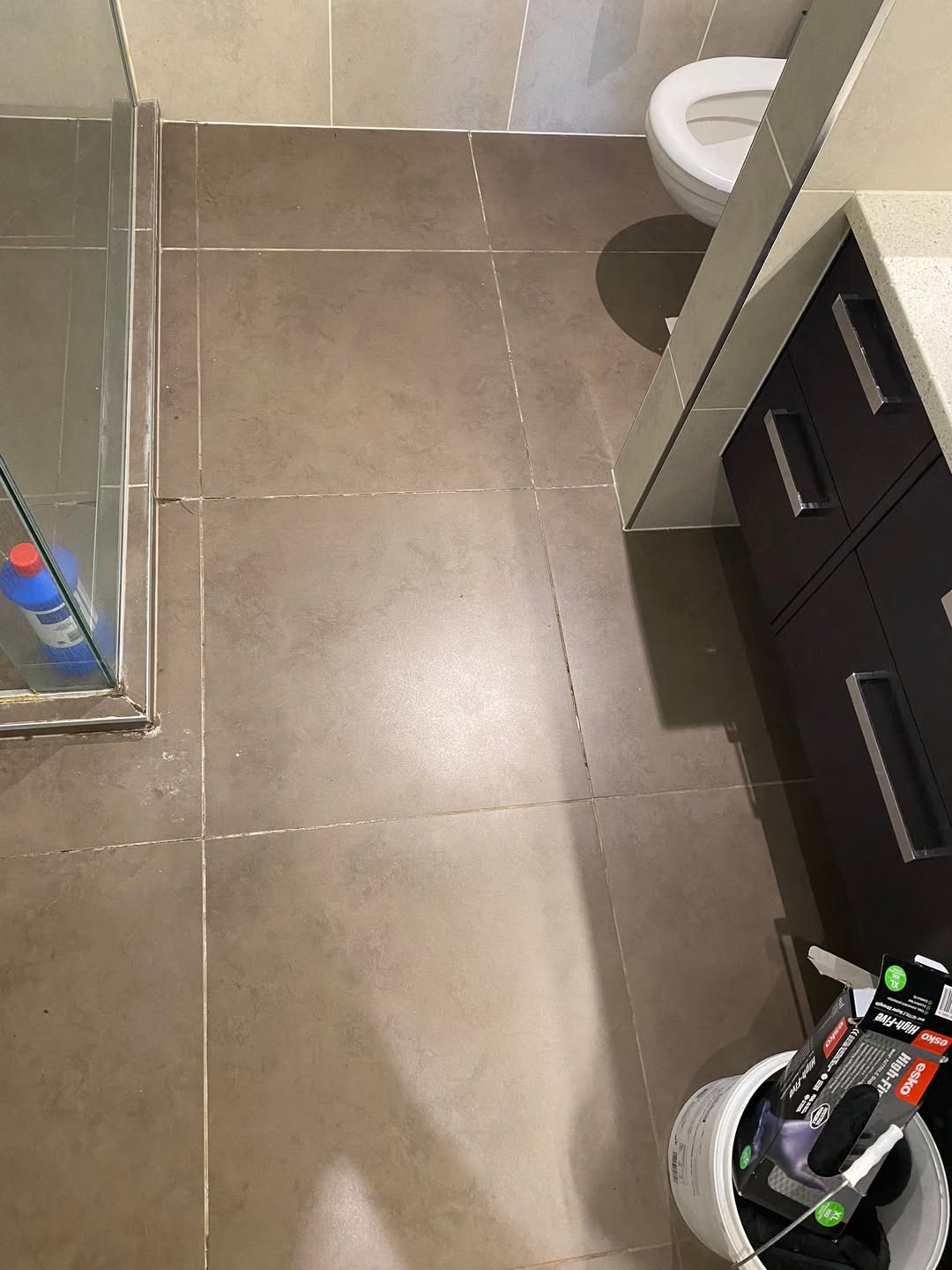 Before restoration: bathroom floor grout before cleaning